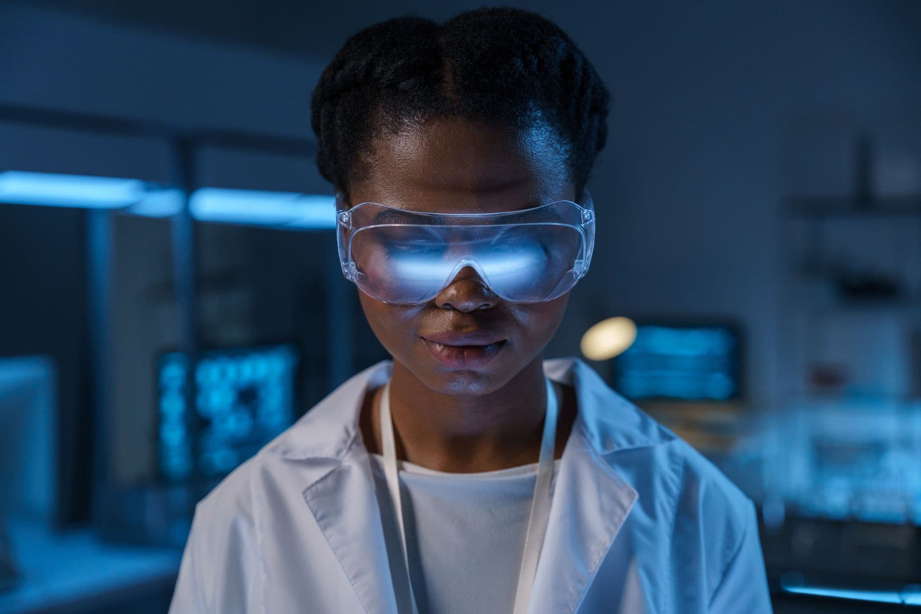 Portrait of a scientist in protective eyewear working in a modern laboratory setting.