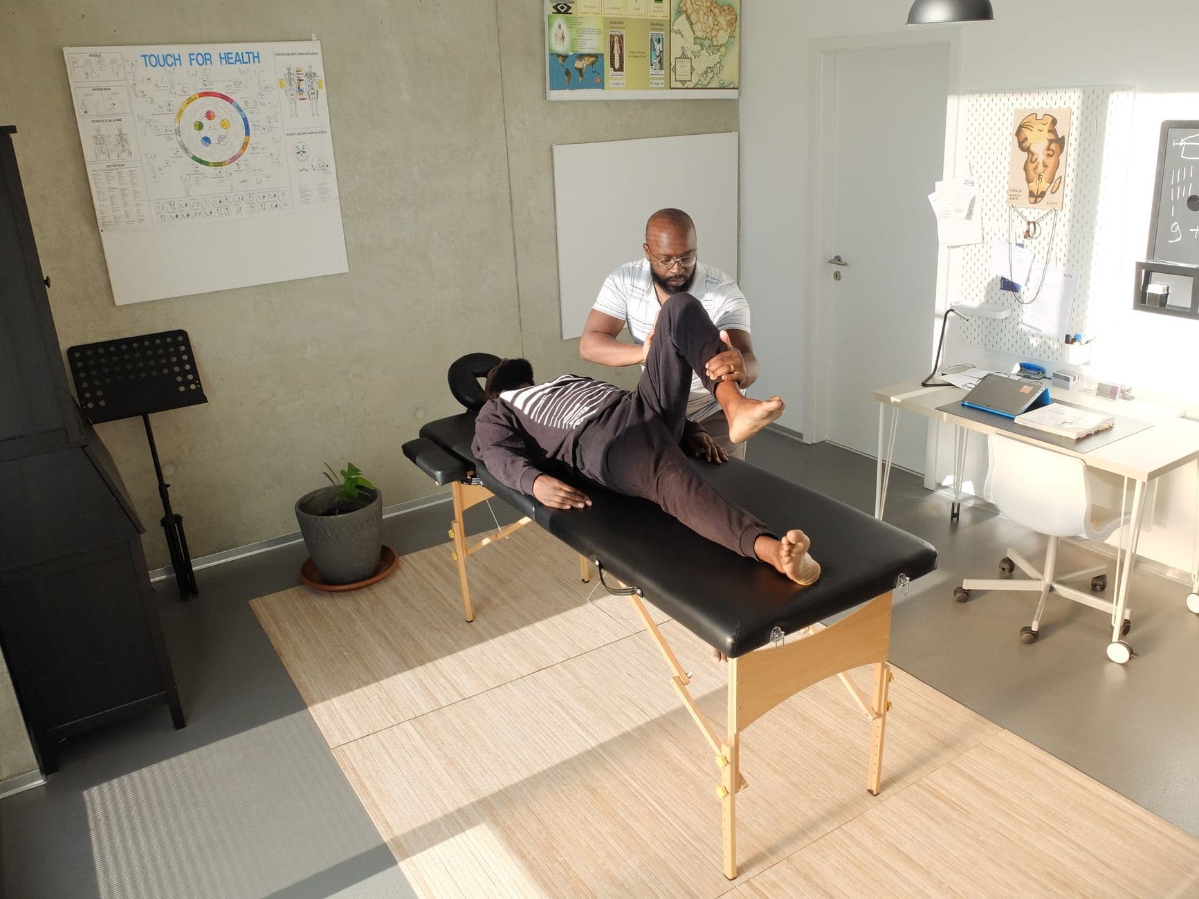Therapist performing therapeutic massage in a clinic setting, emphasizing wellness and relaxation.