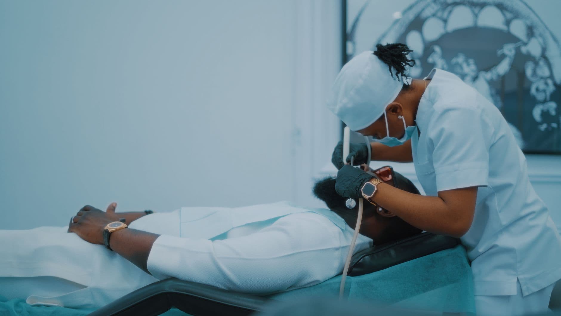 A dental professional performs a procedure on a patient in a Lagos clinic.